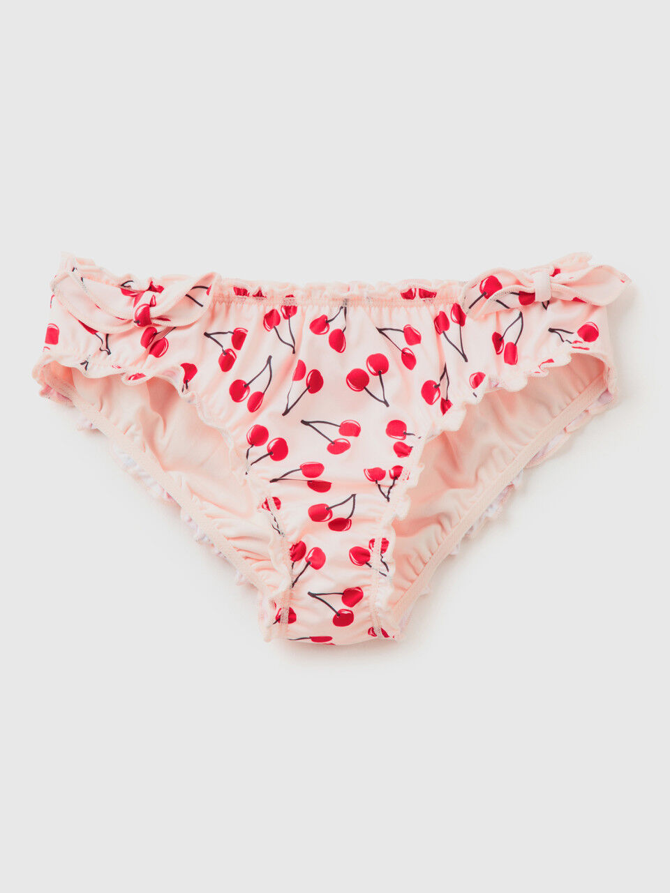 Light pink swim bottoms with cherry pattern