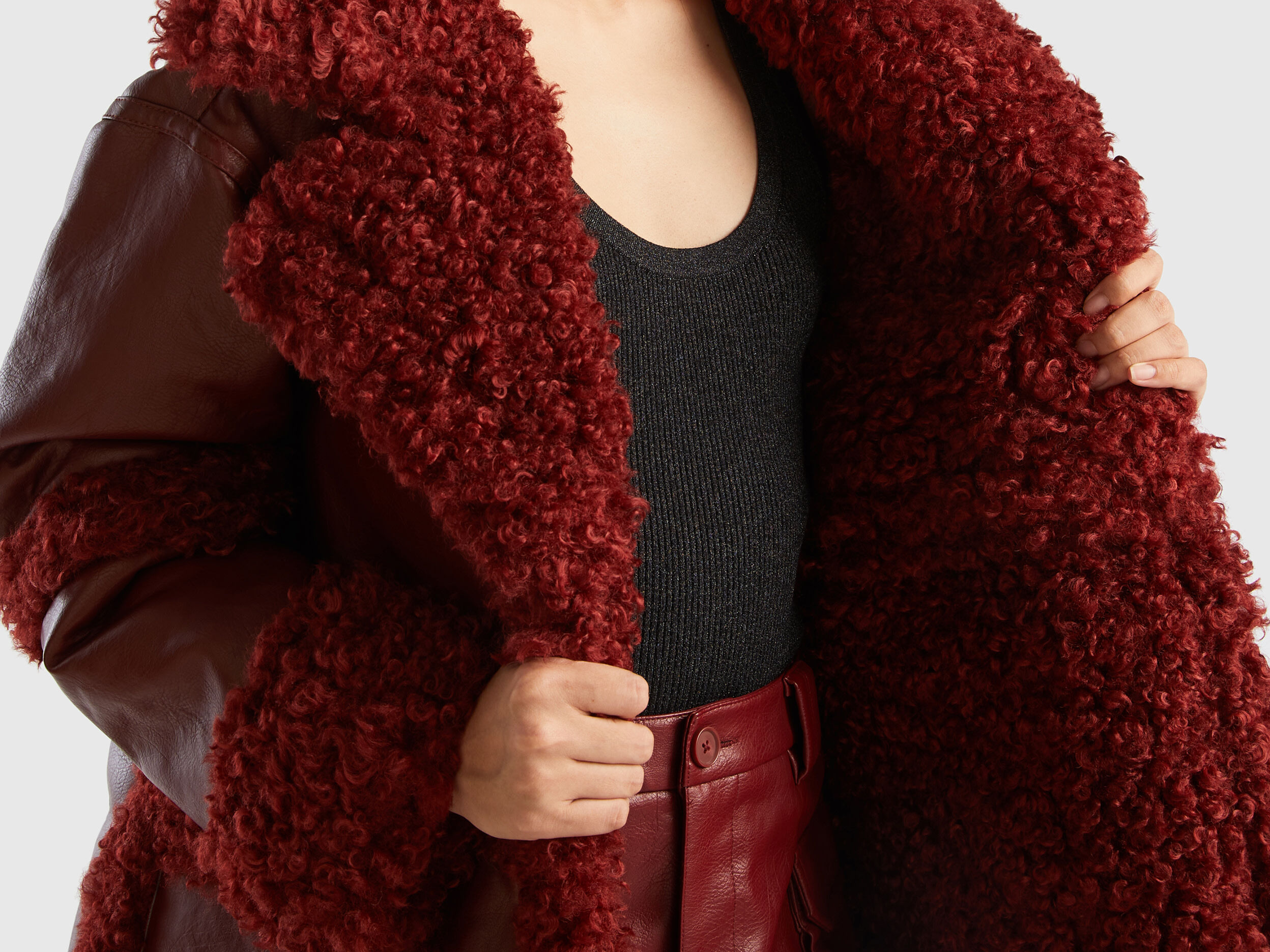 Coat in imitation leather with faux fur