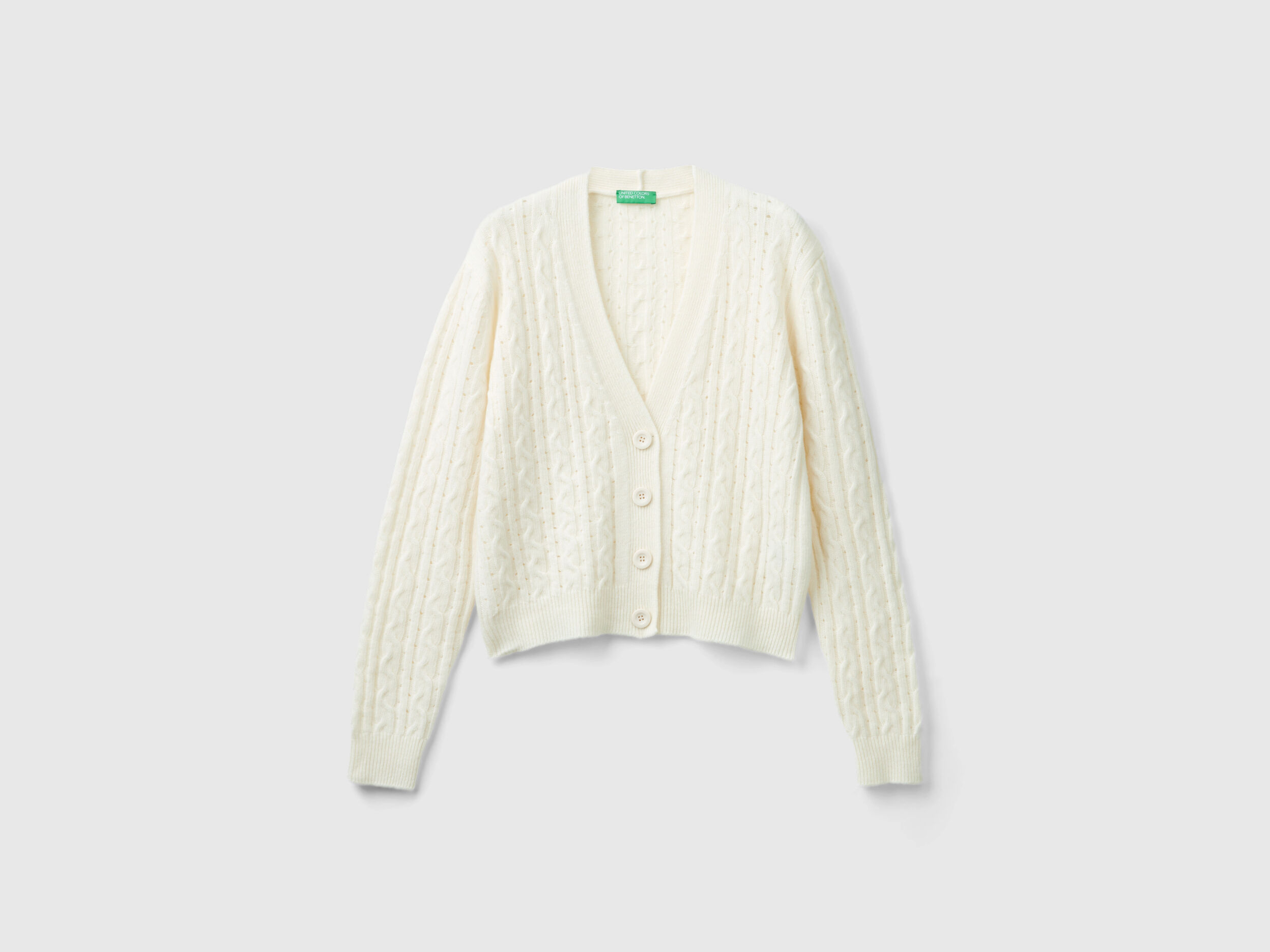 Boxy fit cardigan with cable knit and perforations - Creamy White | Benetton