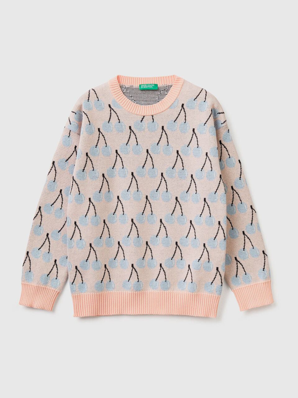Pink sweater with cherry pattern