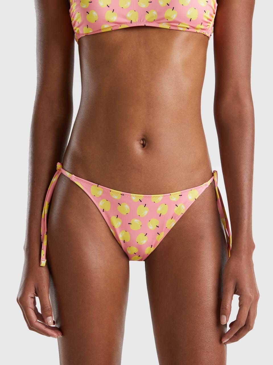 Benetton pink swim bottoms with apple pattern. 1